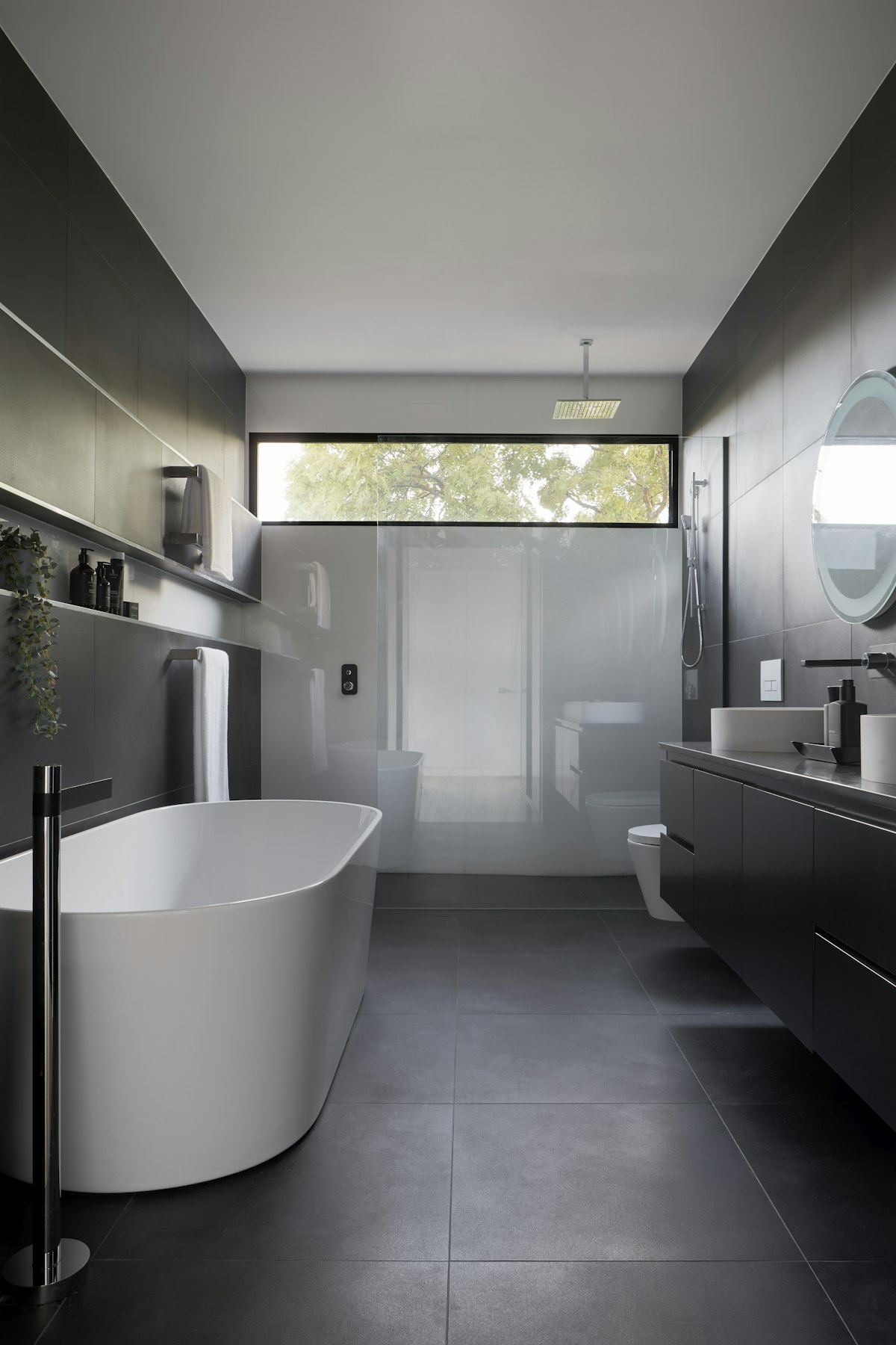 Modern dark bathroom with freestanding bath
